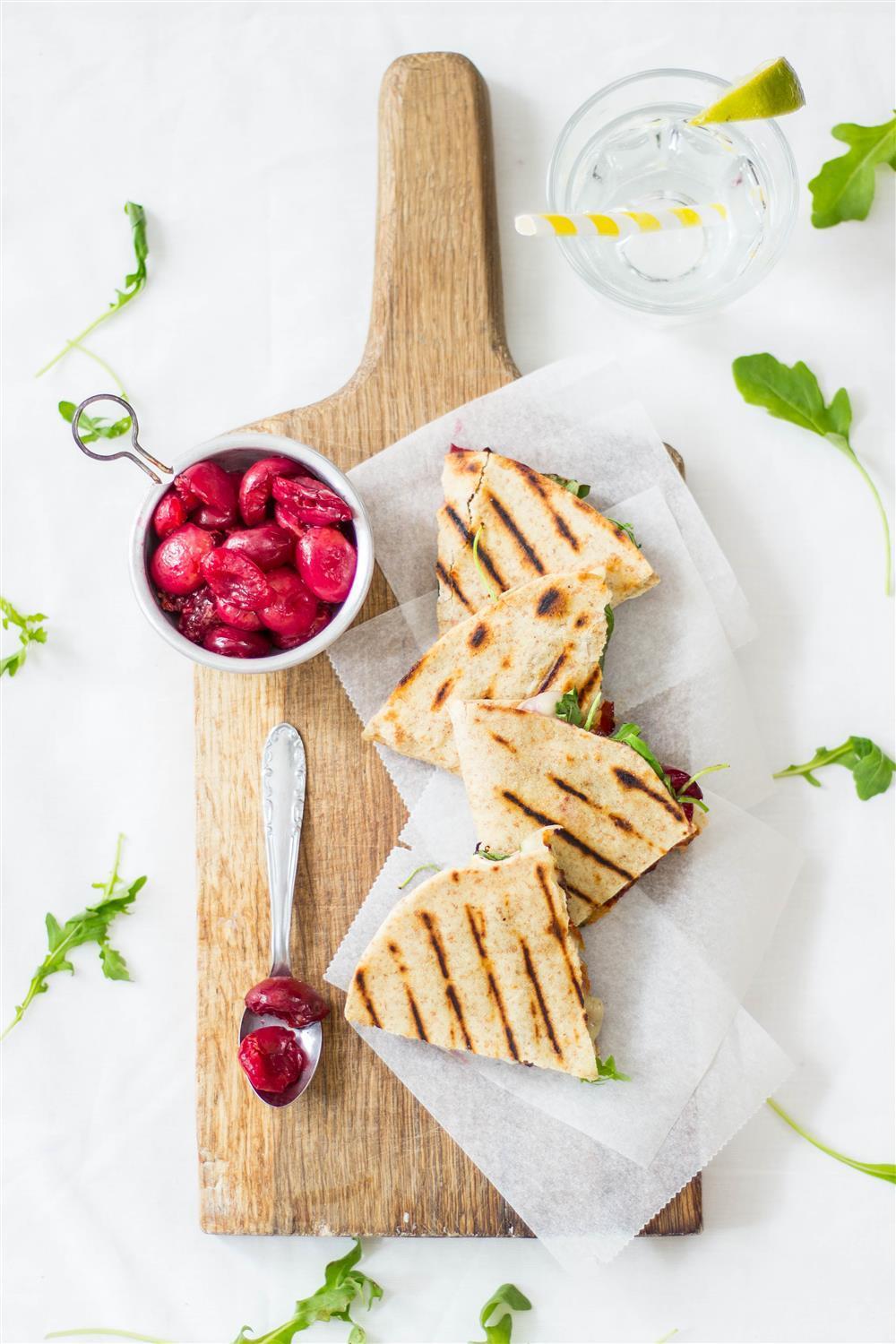 A simple recipe for the perfect grilled quesadilla with cherries, gooey brie and bacon for a summer barbaque party.