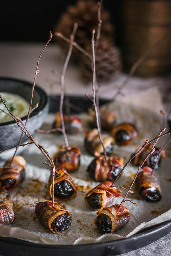 Indulgent finger food for the best party you'll ever throw, but not without these crispy bacon wrapped prunes and a decadent herbed feta dip!