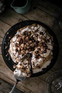 Beautiful layers of crispy and chewy meringue, decadent chocolate ganache and fluffy whipped hazelnut cream are what make this delicious chocolate hazelnut pavlova cake worth celebrating this blog's first birthday.