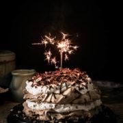 Beautiful layers of crispy and chewy meringue, decadent chocolate ganache and fluffy whipped hazelnut cream are what make this delicious chocolate hazelnut pavlova cake worth celebrating this blog's first birthday.