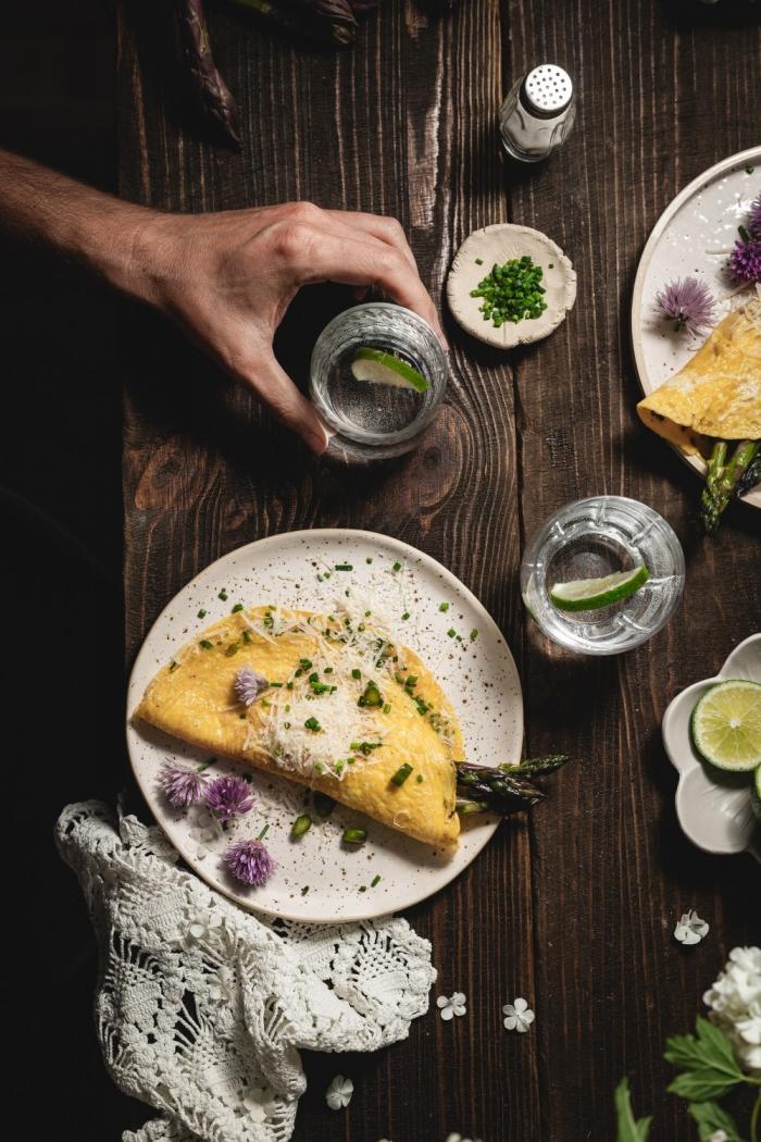 Perfect savory breakfast - soft and creamy asparagus omelet with parmesan cheese and some fresh chives. What could be better?