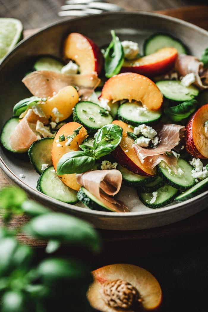 This refreshing Cucumber and peach salad is the perfect intro to Summer! With some prosciutto, feta cheese, and spicy basil dressing it's a winner!
