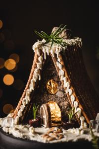Prepare to dazzle your guests with this savory gingerbread house shaped as a holiday cabin. Add it to your charcuterie board and it will be a perfect match!