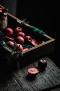 a photo oh red apples on a dark surface for arcticle How to read photos so you can imrove your food photography by Anja Burgar from Use Your Noodles blog