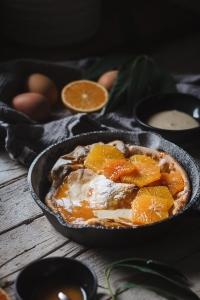 Orange Dutch baby. Light and airy topped with orange sauce, whipped honey and fresh oranges. It's made in no time! My favorite Winter breakfast lately because it's naturally sweet but also fresh at the same time.