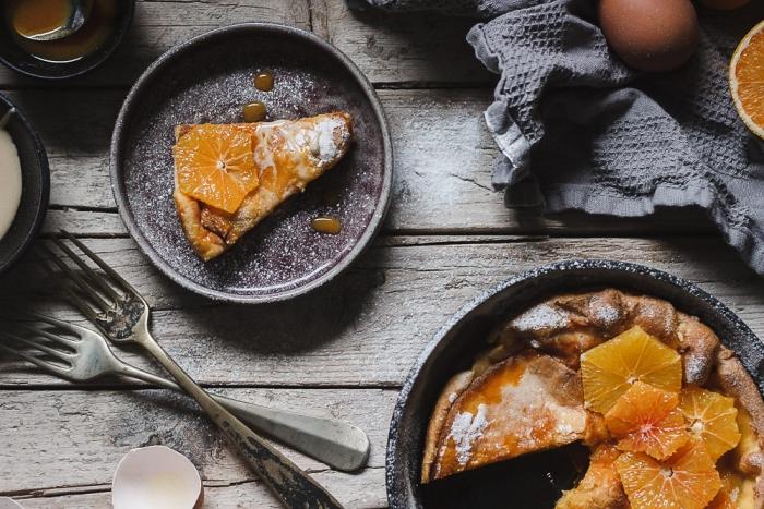 Orange Dutch baby. Light and airy topped with orange sauce, whipped honey and fresh oranges. It's made in no time! My favorite Winter breakfast lately because it's naturally sweet but also fresh at the same time.