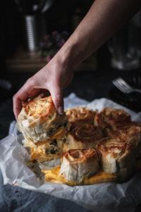 This chicken spanakopita (Greek spinach pie) is the best comfort food I can imagine for spring. Hearty and rich, flavored with cheeses, leeks and chicken, but also loaded with fresh spinach. And to top it all, it make s a perfect early picnic dish, since it is pull-apart. I don't think anything could make me more excited right now.