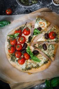 Italian flavors with a twist in one delicious spicy goat cheese pesto pizza loaded with fresh cherry tomatoes, mozarella and black olives. I could eat this pizza every day!