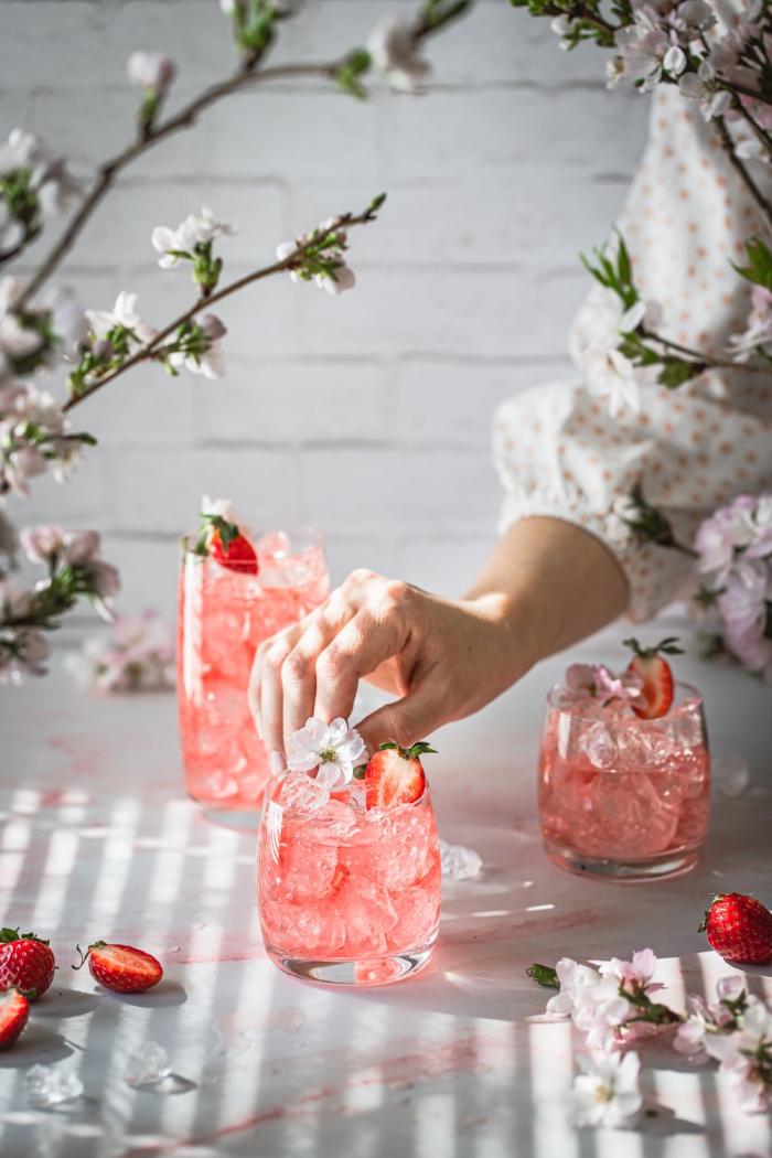Learn this easy recipe for a fruity strawberry gin and tonic with homemade strawberry simple syrup. Only a few simple ingredients but so much flavor!