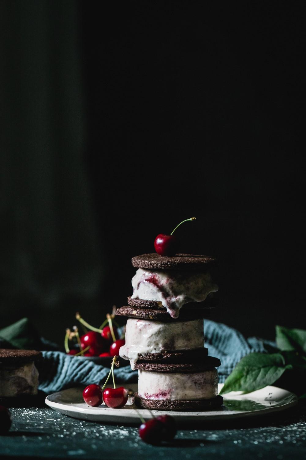 Wrap your hands around something wonderful with this vegan cherry almond ice cream between two delicious almond chocolate cookies.