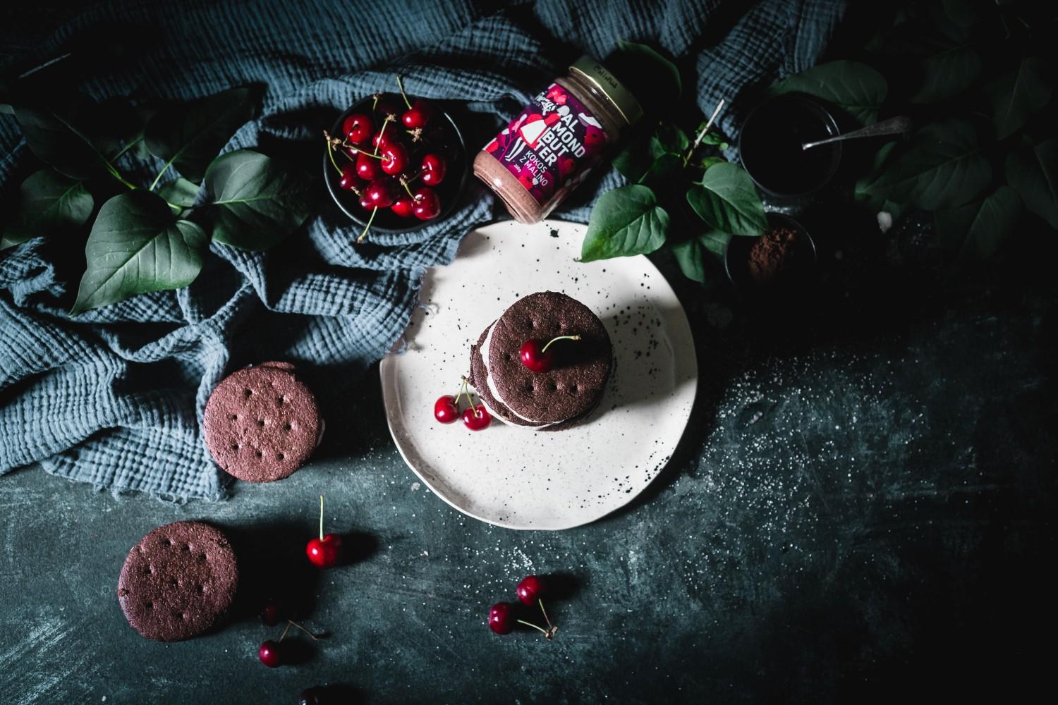 Wrap your hands around something wonderful with this vegan cherry almond ice cream between two delicious almond chocolate cookies.